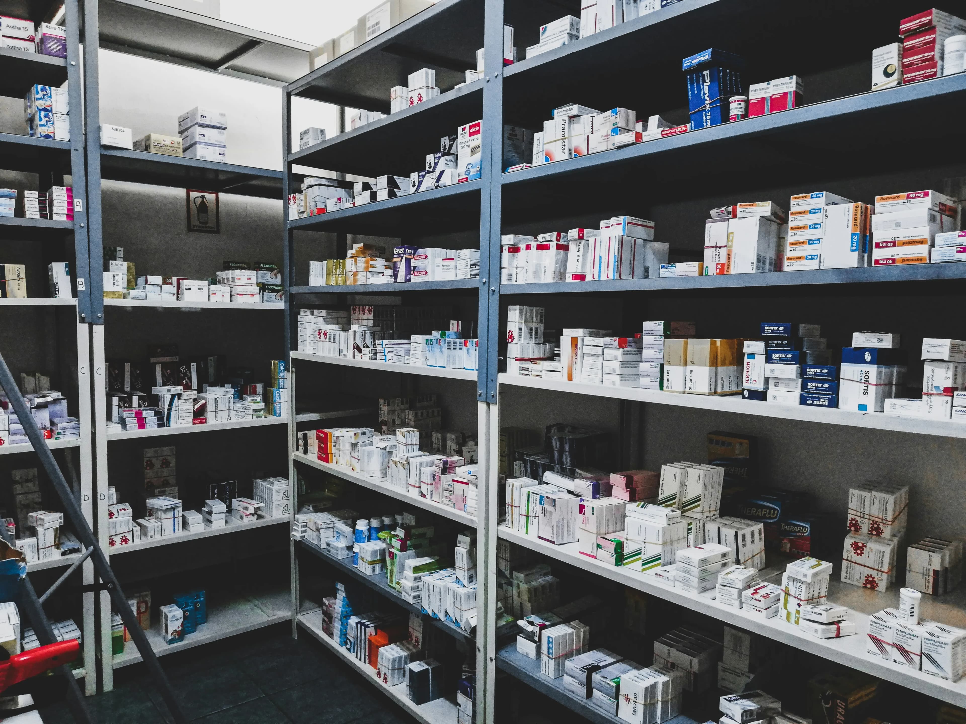 Resolven Pharmacy prescription dispensing area with medication shelves and NHS prescriptions